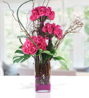 Arrangement of 48 Pink roses with fillers in a glass vase. (3 bunch of 16 roses each in a vase) Modern Arrangement