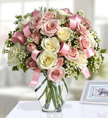 12 Pink and 12 White Rose in a vase with pink ribbons in between. (one sided round arrangement) Celebrating Pink